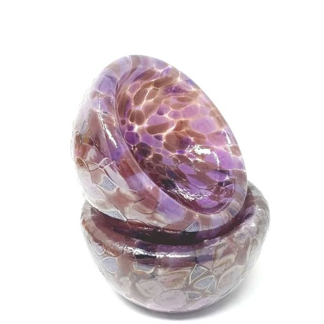 Two stacked violet and copper double-walled glass bowls.