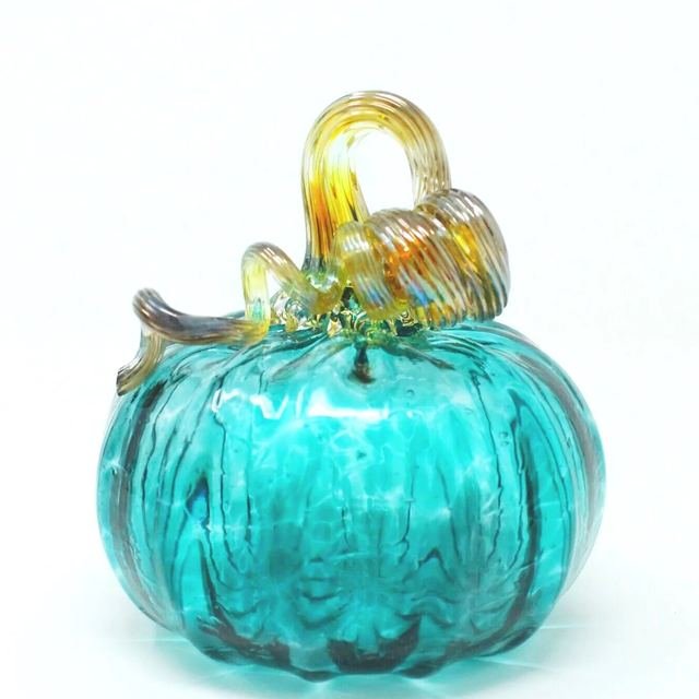 Teal ribbed glass pumpkin with an amber stem.